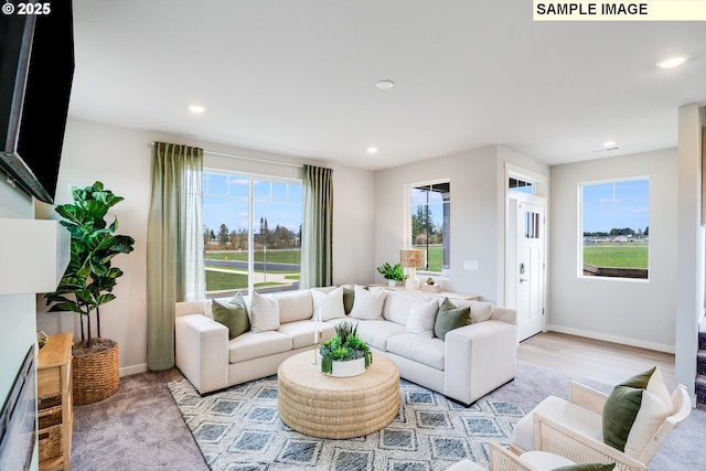 living area with recessed lighting and baseboards