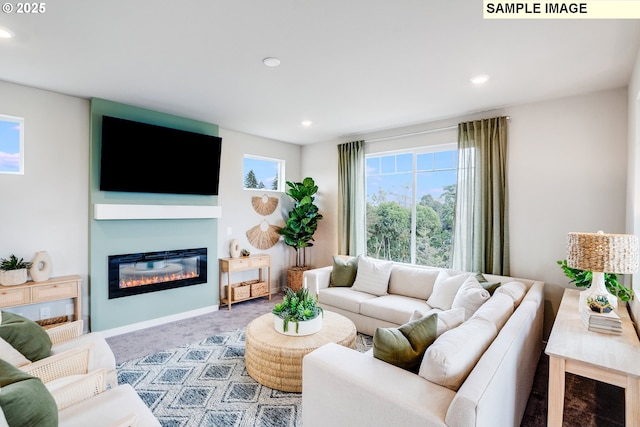 carpeted living area featuring a glass covered fireplace and recessed lighting