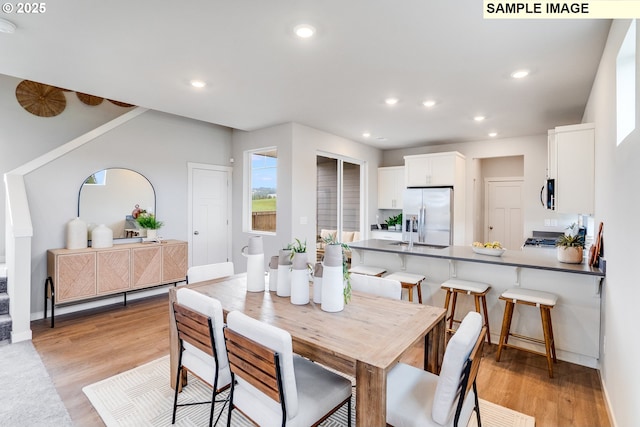 dining area featuring light wood-style floors, recessed lighting, and baseboards