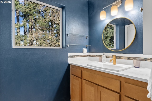 bathroom with vanity and decorative backsplash