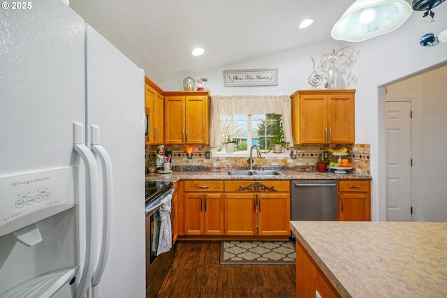 kitchen featuring tasteful backsplash, lofted ceiling, sink, stainless steel appliances, and dark wood-type flooring