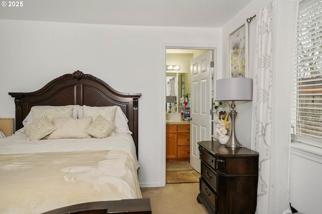 carpeted bedroom with ensuite bath