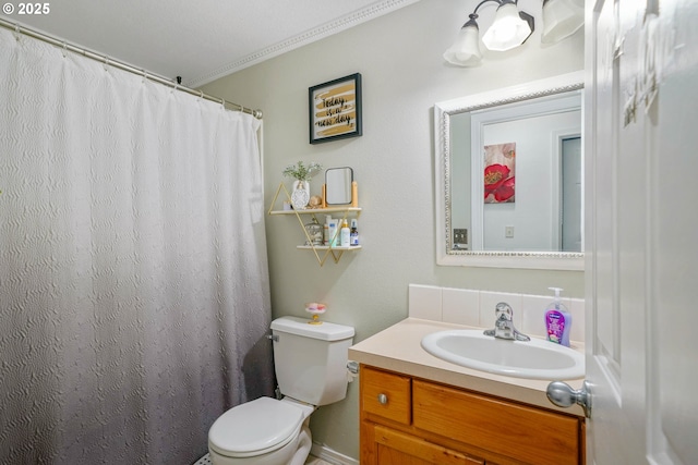 bathroom featuring vanity, ornamental molding, and toilet