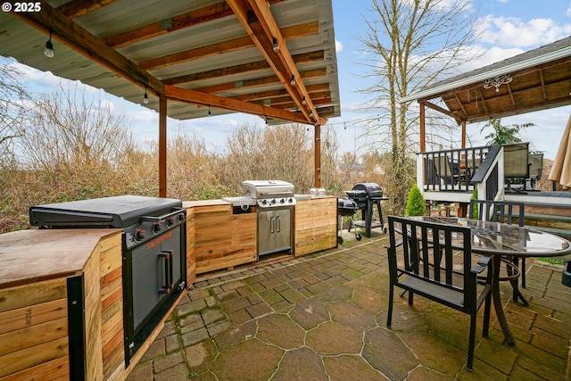 view of patio / terrace with a gazebo, grilling area, and an outdoor kitchen