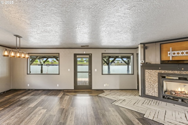 2039 N Jantzen Ave, Portland, OR 97217 - unfurnished living room with a textured ceiling, wood finished floors, and a fireplace