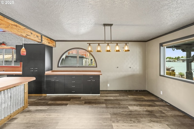 2039 N Jantzen Ave, Portland, OR 97217 - unfurnished dining area with a textured ceiling, dark wood-type flooring, and baseboards