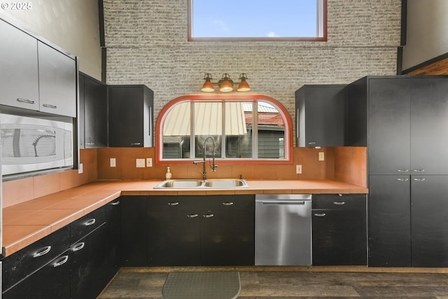 2039 N Jantzen Ave, Portland, OR 97217 - kitchen featuring a sink, tile countertops, dishwasher, built in microwave, and dark cabinets