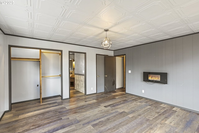 2039 N Jantzen Ave, Portland, OR 97217 - unfurnished bedroom featuring an ornate ceiling, wood finished floors, multiple closets, baseboards, and a glass covered fireplace