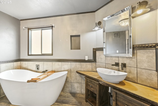 2039 N Jantzen Ave, Portland, OR 97217 - full bathroom with a soaking tub, tile walls, wainscoting, and vanity