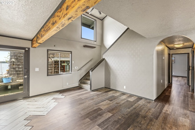 2039 N Jantzen Ave, Portland, OR 97217 - unfurnished living room featuring stairway, a textured ceiling, arched walkways, and wood finished floors