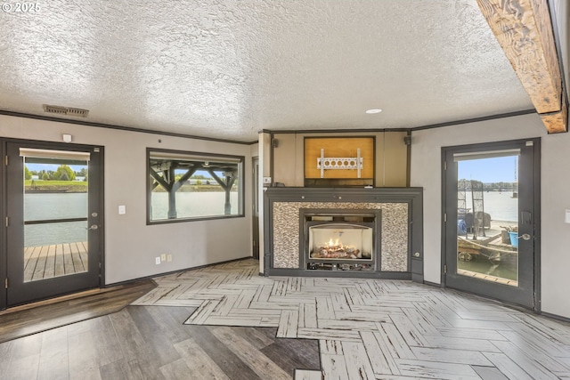 2039 N Jantzen Ave, Portland, OR 97217 - unfurnished living room with baseboards, a water view, a fireplace, and a textured ceiling