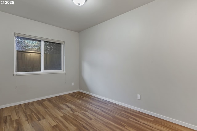 spare room featuring wood-type flooring