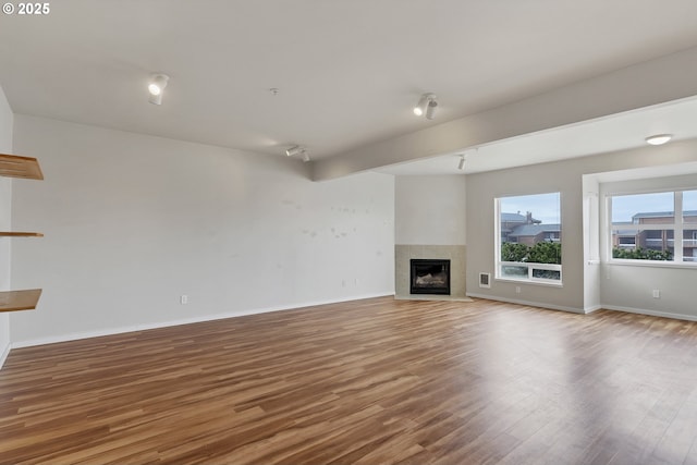 unfurnished living room with hardwood / wood-style floors and a fireplace