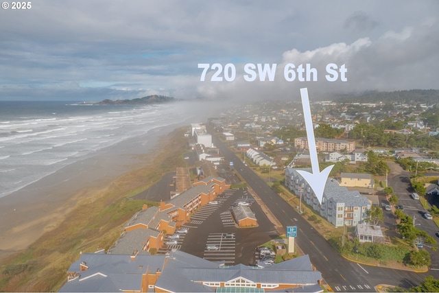 drone / aerial view featuring a view of the beach and a water view