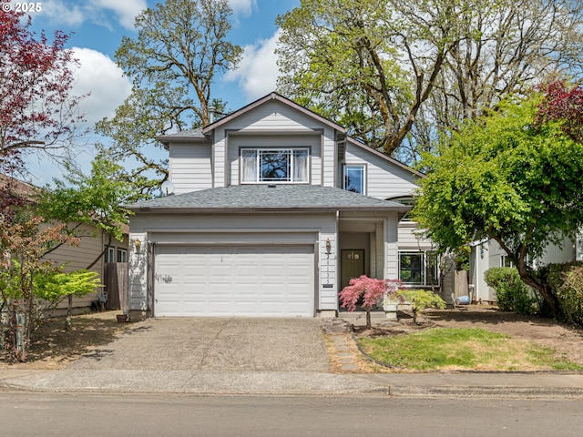 traditional home featuring a garage, a shingled roof, and concrete driveway