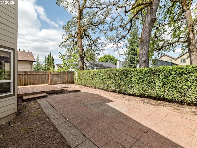 view of patio featuring a fenced backyard and a deck