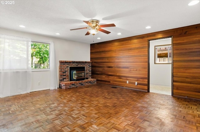 19555 SW Cascadia St, Beaverton, OR 97078 - unfurnished living room with wooden walls, ceiling fan, recessed lighting, baseboards, and a textured ceiling