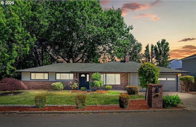 19555 SW Cascadia St, Beaverton, OR 97078 - ranch-style house featuring driveway, an attached garage, brick siding, a yard, and a chimney