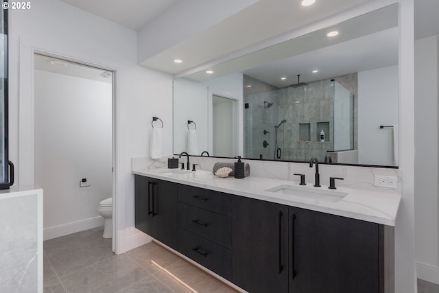 1515 NW Spring St, Newport, OR 97365 - bathroom featuring toilet, double vanity, a stall shower, baseboards, and recessed lighting