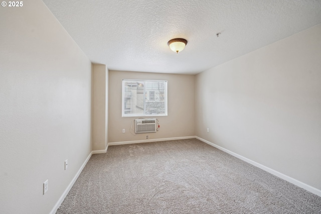 spare room with a textured ceiling, carpet, and a wall mounted air conditioner