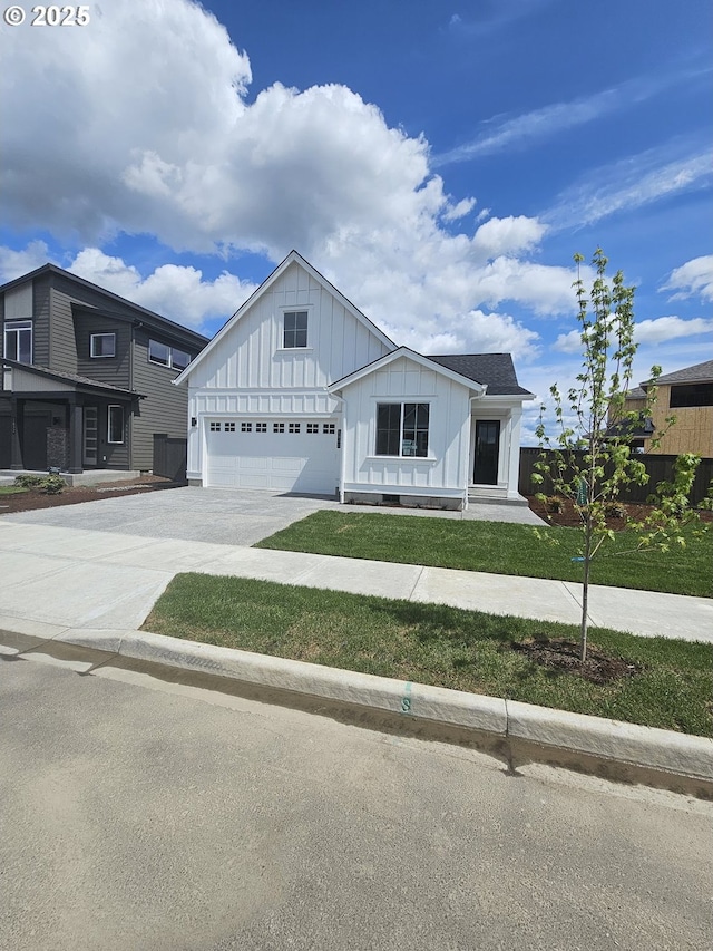 3840 S 44th Ln, Ridgefield, WA 98642 - modern farmhouse style home featuring an attached garage, a front lawn, board and batten siding, and driveway