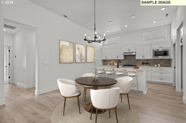 3840 S 44th Ln, Ridgefield, WA 98642 - dining space with baseboards, a chandelier, light wood-style flooring, and visible vents