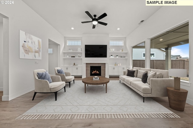 3840 S 44th Ln, Ridgefield, WA 98642 - living area featuring a ceiling fan, baseboards, wood finished floors, a tile fireplace, and visible vents