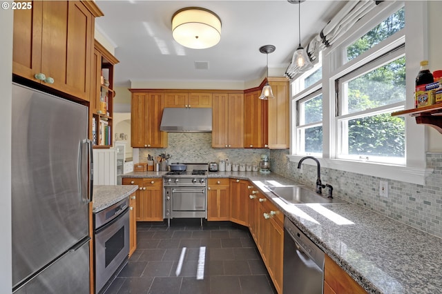 803 NE Laurelhurst Pl, Portland, OR 97232 - kitchen featuring appliances with stainless steel finishes, under cabinet range hood, a sink, dark tile patterned flooring, and tasteful backsplash