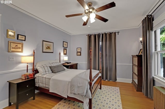 803 NE Laurelhurst Pl, Portland, OR 97232 - bedroom featuring radiator heating unit, light wood finished floors, ornamental molding, baseboards, and a ceiling fan
