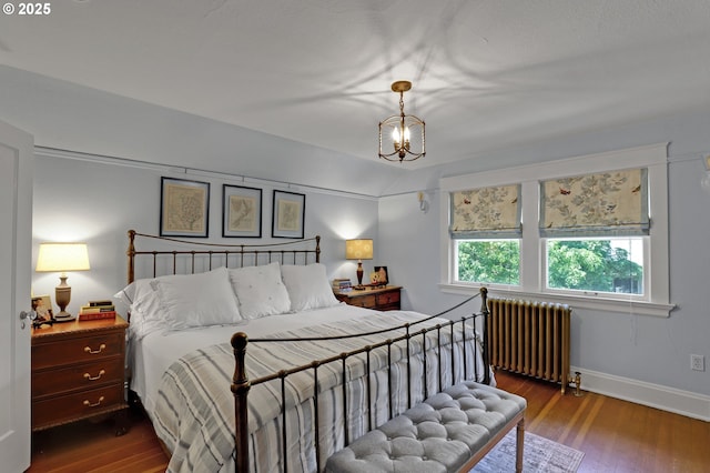 803 NE Laurelhurst Pl, Portland, OR 97232 - bedroom featuring radiator, wood finished floors, baseboards, and a chandelier