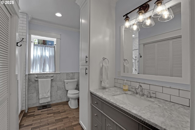 803 NE Laurelhurst Pl, Portland, OR 97232 - bathroom featuring a closet, tile walls, vanity, brick patterned flooring, and toilet