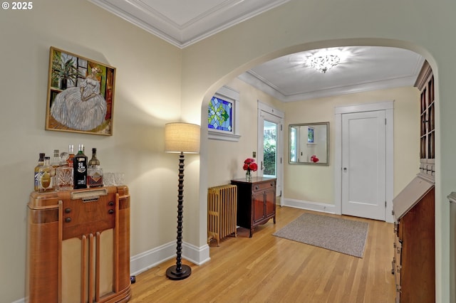 803 NE Laurelhurst Pl, Portland, OR 97232 - foyer entrance with arched walkways, wood finished floors, ornamental molding, baseboards, and radiator heating unit