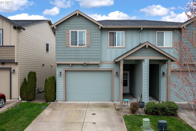 view of property featuring a garage, board and batten siding, and driveway