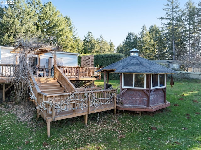 wooden terrace with a gazebo and a lawn