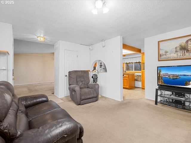 carpeted living room featuring a textured ceiling