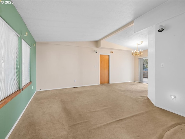 unfurnished room with carpet floors, vaulted ceiling with beams, a textured ceiling, and an inviting chandelier