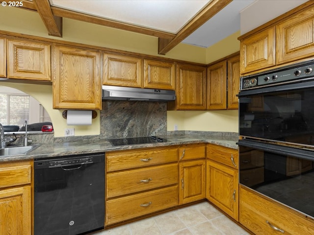 kitchen with sink, light tile patterned floors, dark stone countertops, backsplash, and black appliances