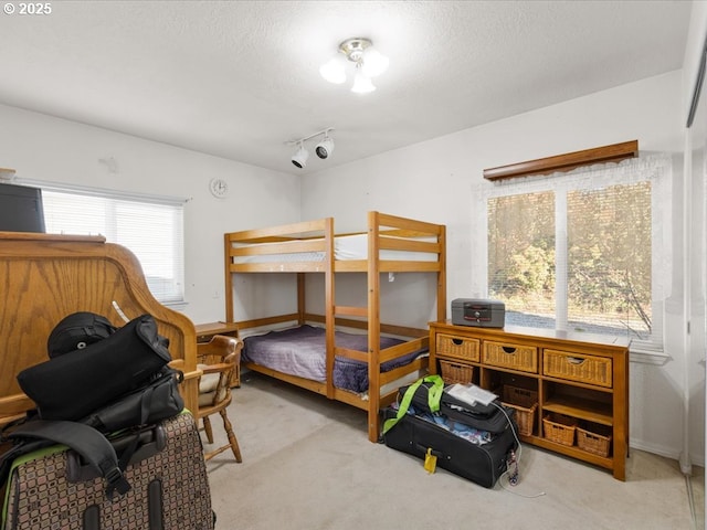 carpeted bedroom featuring a textured ceiling