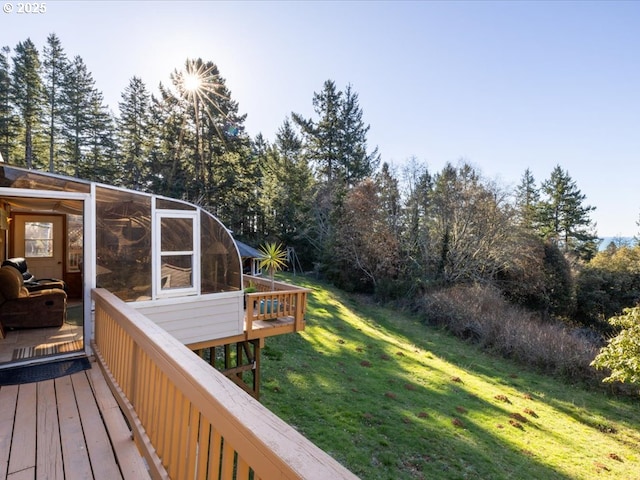 deck with a yard and a sunroom