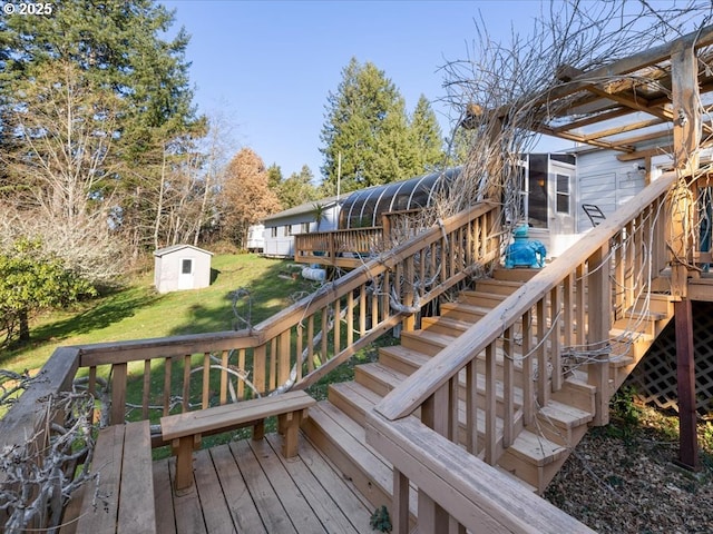 wooden deck featuring a yard, a sunroom, and a shed