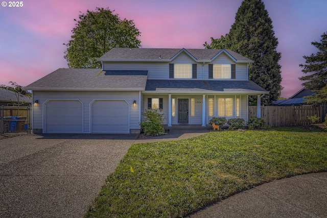 traditional-style home with driveway, a garage, covered porch, and a shingled roof