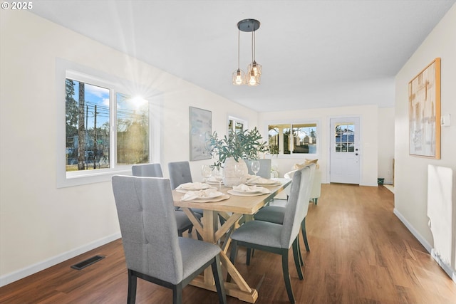 dining space with a chandelier and hardwood / wood-style flooring