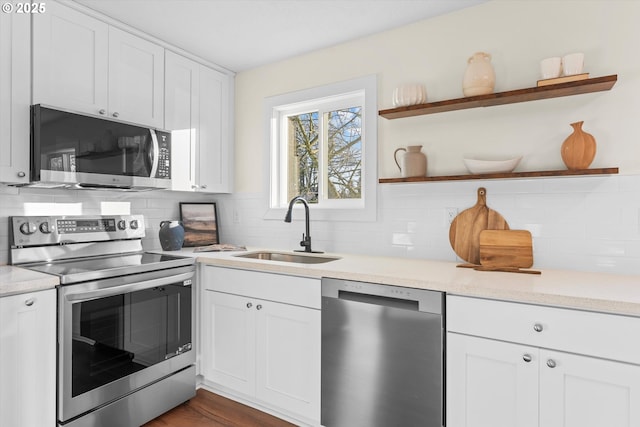 kitchen featuring sink, white cabinetry, appliances with stainless steel finishes, and tasteful backsplash