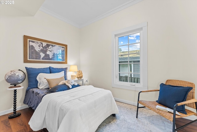 bedroom featuring ornamental molding and hardwood / wood-style floors