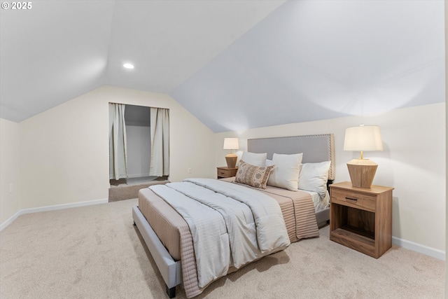 bedroom with light colored carpet and vaulted ceiling