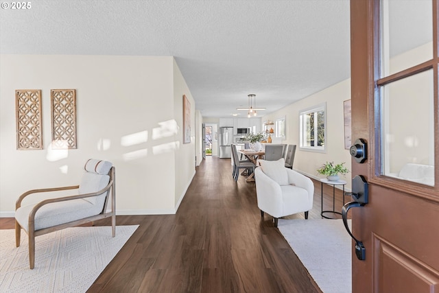 entrance foyer with ceiling fan, dark hardwood / wood-style floors, and a textured ceiling