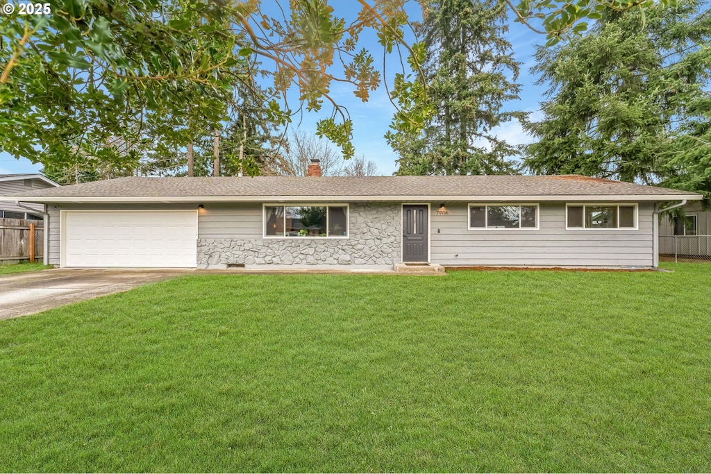 ranch-style house with a garage and a front yard