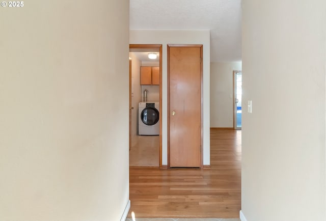 2110 SE 148th Pl, Portland, OR 97233 - corridor with light wood-style flooring, baseboards, and washer / clothes dryer