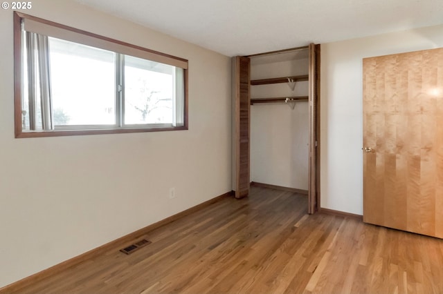2110 SE 148th Pl, Portland, OR 97233 - unfurnished bedroom featuring baseboards, a closet, visible vents, and light wood-style flooring