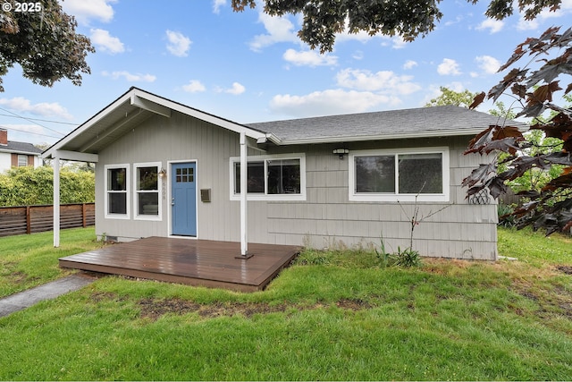 view of front of home with a wooden deck and roof with shingles